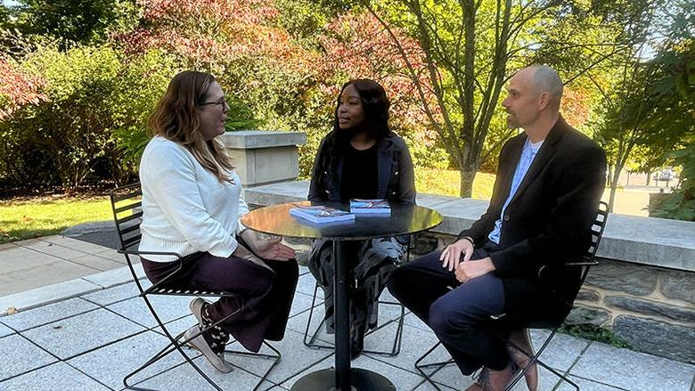 Three people sitting at a table